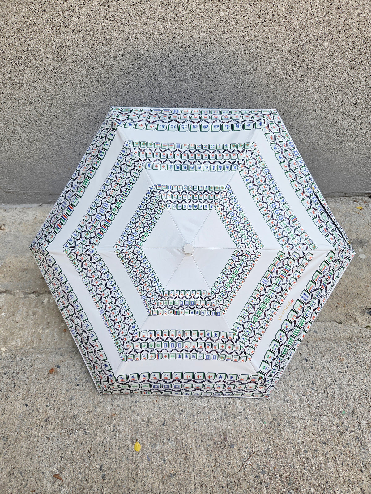 Hexagonal stone table with decorative patterns on a concrete surface