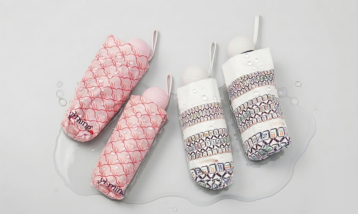 Set of four patterned folded unbrellas on a white background